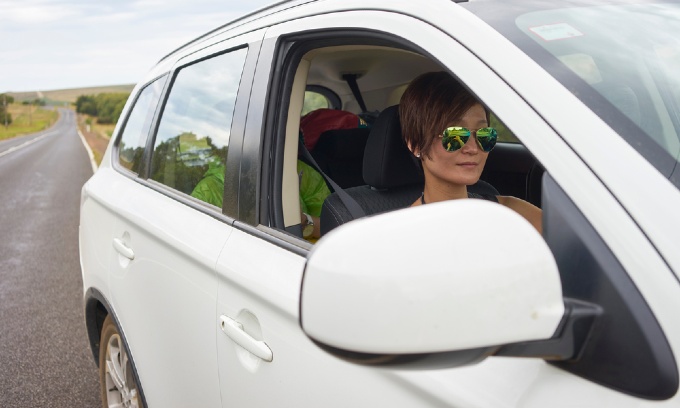 A young woman driving a car