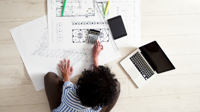 Off-the-plan buyer sitting on floor crunching numbers
