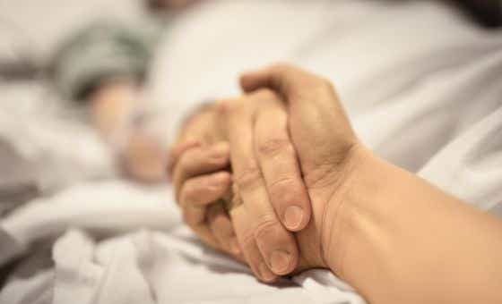 A couple holding hands in a hospital
