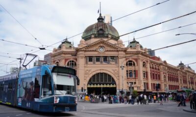 A tram moves past Flinders Street Station representing the best suburbs to invest in Melbourne.