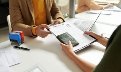 A woman recieves her visa application back.