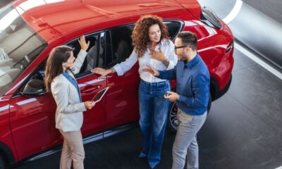 A couple discussing car options at a dealership representing the title, "Car finance options: What type of car loan should you get?"