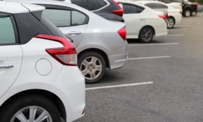 Rear view of cars in a parking, representing the title, "Hatchback vs sedan: How to make your decision"