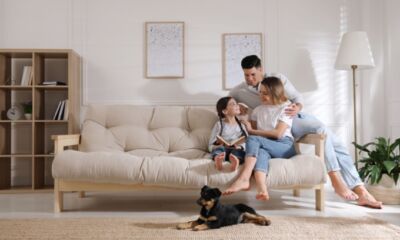 A family sit on the couch and think about home insurance deals, offers & discounts.