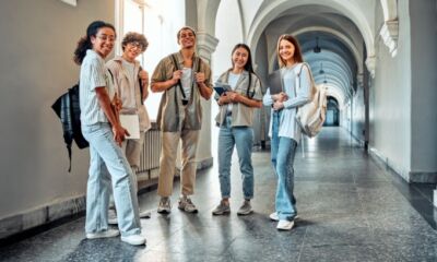 A group of university students stand in the hallway representing how much HECS do I pay?