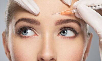 Close-up of a woman’s face receiving an injection, illustrating the question “How much is Botox?”