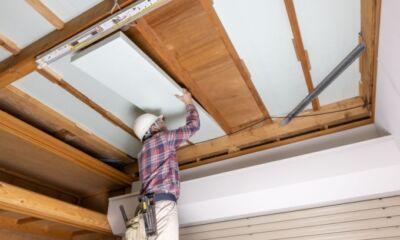 An image of a person installing roof insulation representing the title, 'how much does roof insulation cost'.