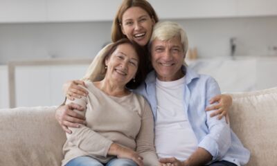 A girl hugging her elderly parents representing the title, "How to transfer property to family or friends."