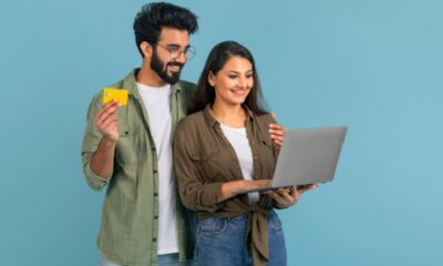 A couple look at a laptop while applying for a joint credit card.