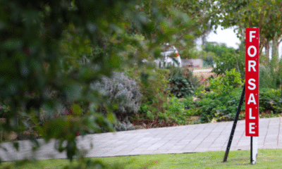 For sale sign outside of home.