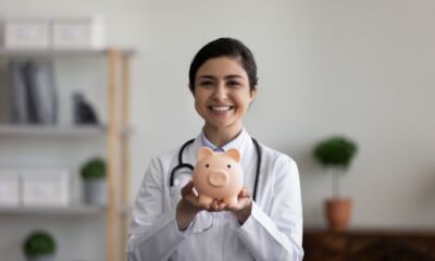A doctor holding a piggy bank, representing the topic, "Medical personal loans: what are your options?"