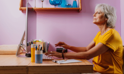 Pensioner sitting at desk.