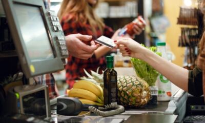 A man hands over his supermarket membership card at the checkout.