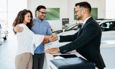 A couple discusses with a car dealer about the best ways to finance a car in Australia.
