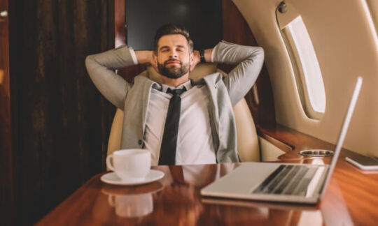 Business man relaxes on flight