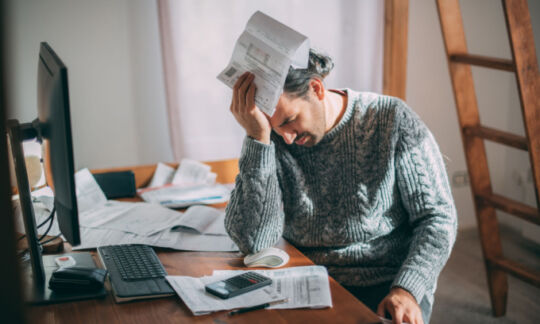 An upset man contemplates what can void home insurance.
