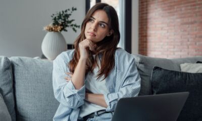 A woman sits with her laptop pondering what are break costs?