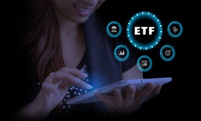 A woman uses a tablet to search for ETFs representing best etf australia.