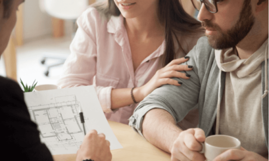 Two people looking at house -plans